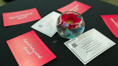 An image of a centerpiece and high-top table at an Aresty event