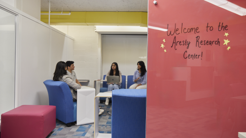 Students sitting in a group talking in the Aresty Research Center