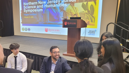 High school students speaking with a presenter at the Northern New Jersey Junior Humanities and Science Symposium