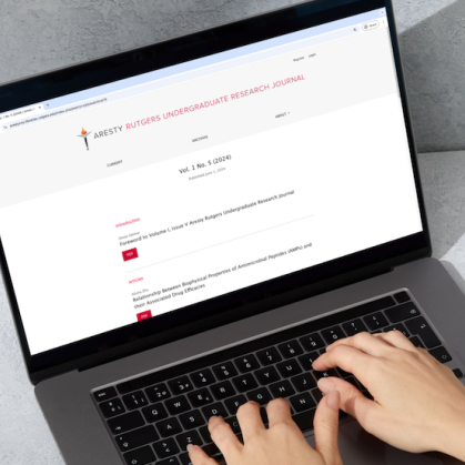 Smart mockup of the fifth edition of the Aresty Undergraduate Research Journal being viewed on a laptop cropped 