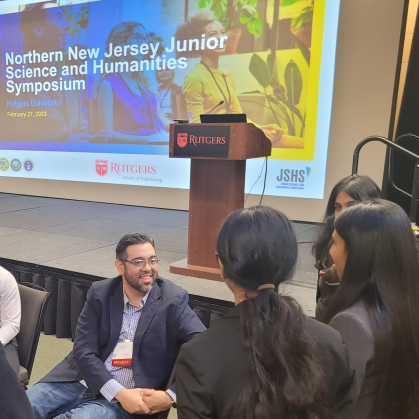 High school students speaking with a presenter at the Northern New Jersey Junior Humanities and Science Symposium cropped
