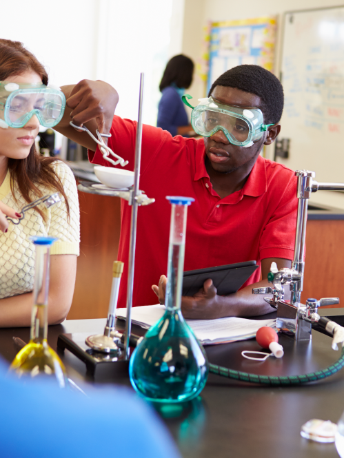 High school students carry out an experiment in a classroom