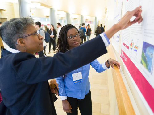 Student presenting research poster at the Aresty Undergraduate Research Symposium