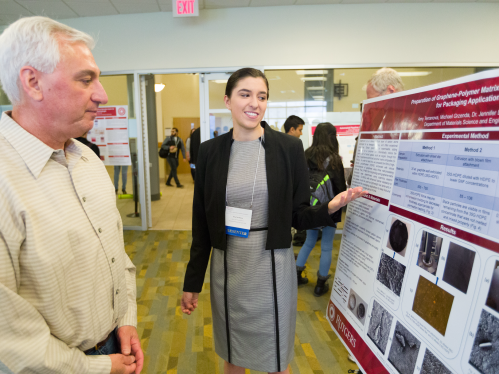 A student presenting her research poster