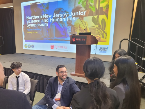 High school students speaking with a presenter at the Northern New Jersey Junior Humanities and Science Symposium