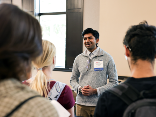 Senior Peer Instructor Siddharth Ghosh Roy speaking with students at the Undergraduate Research Discovery Day event