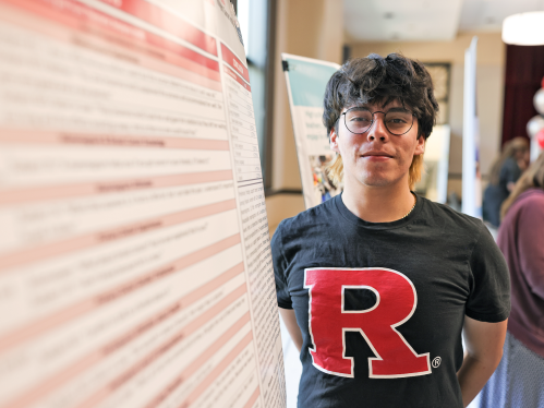Jonathan Julian posing next to his research poster