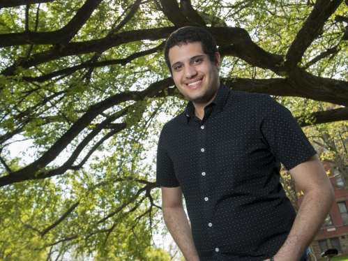 Frederric Kelada posing in front of a tree on campus