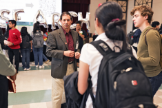 Faculty Director, Eric Gawiser, speaking with students at the Undergraduate Research Discovery Day event