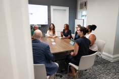 A group of faculty talking and sitting around a table at the Center for Faculty Success office